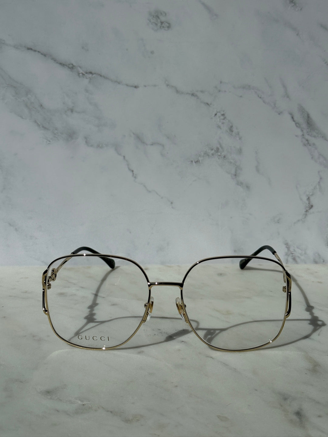 Gold round eyeglass frames with horsebit bridge and black temple arms