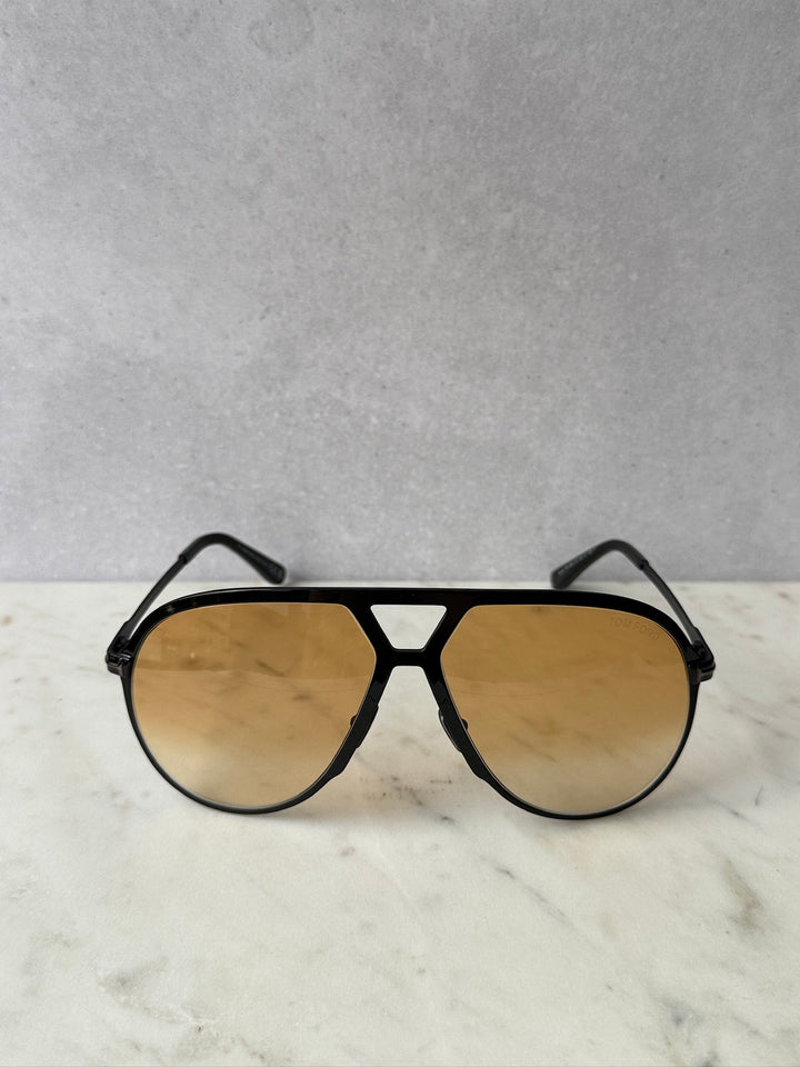 Oversized black aviator sunglasses with amber tinted lenses, front view