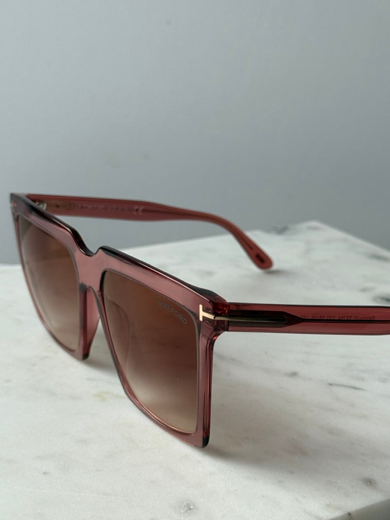 Pink square sunglasses close-up side, brown gradient lenses and T logo hinge