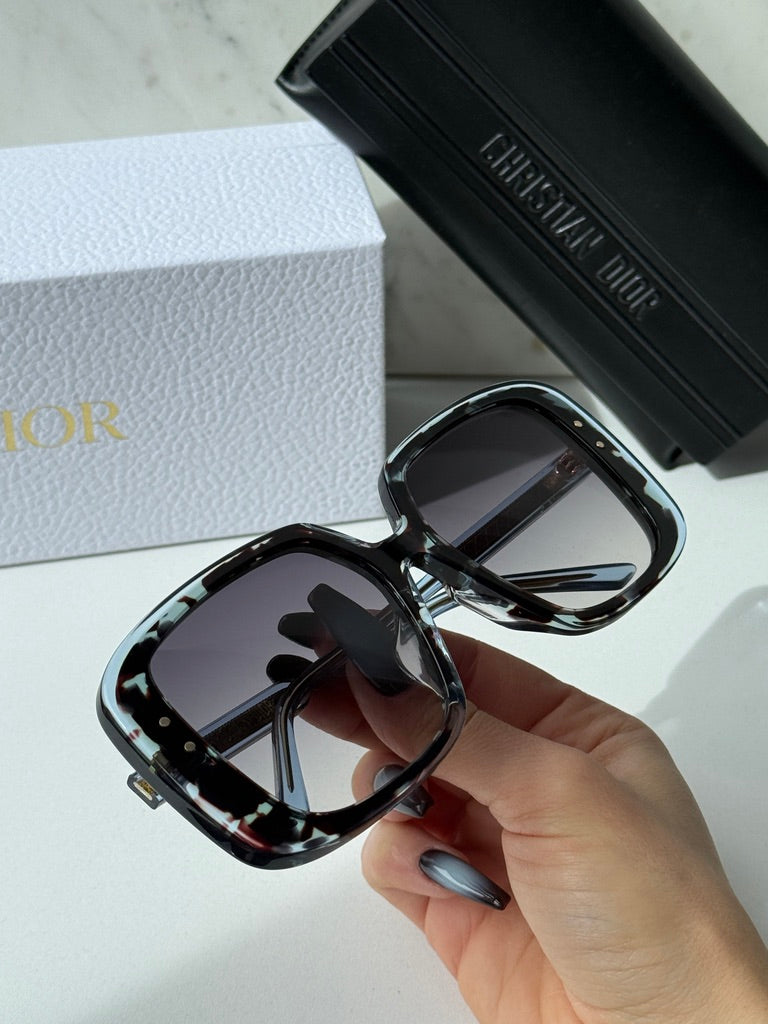Havana blue square sunglasses, hand holding close-up