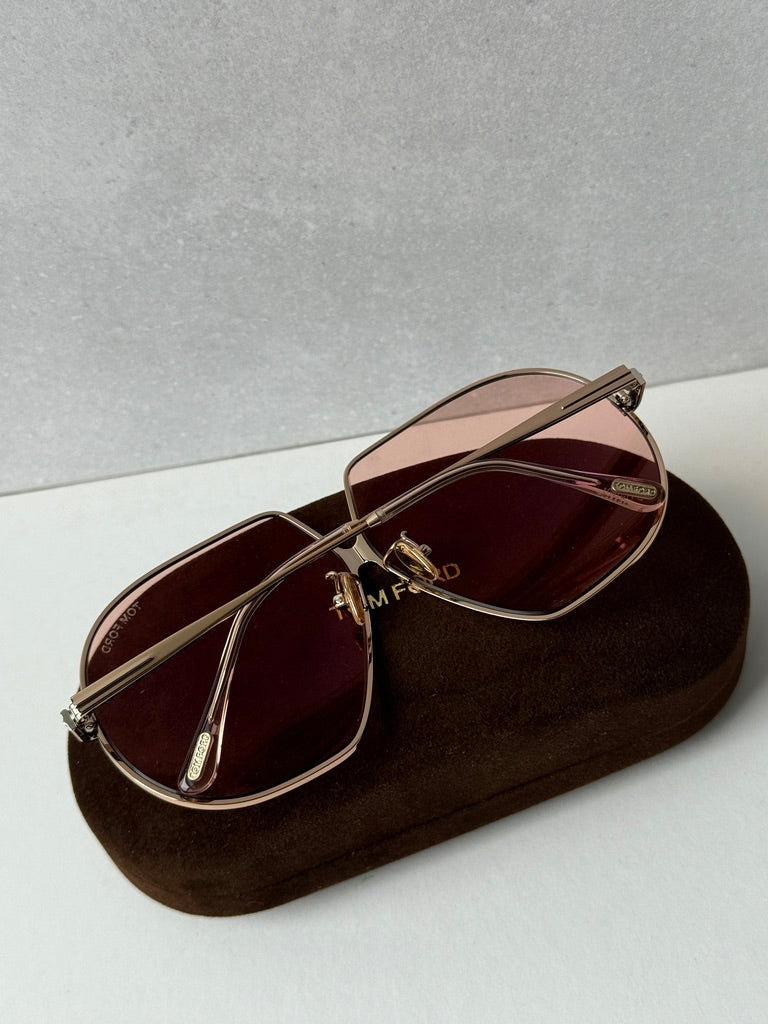 Rose gold oversized sunglasses with rose-tinted lenses and curved metal temples