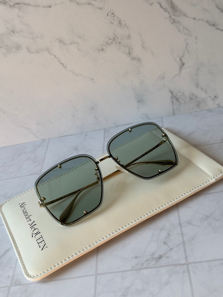 Oversized square sunglasses with green frames and dark green lenses