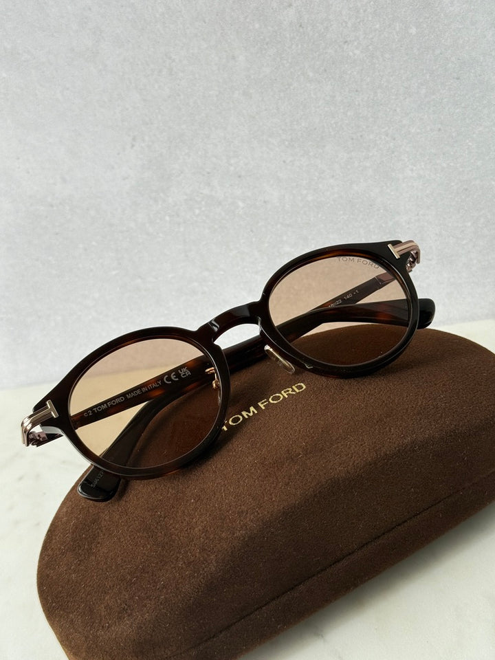 Havana brown round sunglasses with dark lenses and gold-tone hinges
