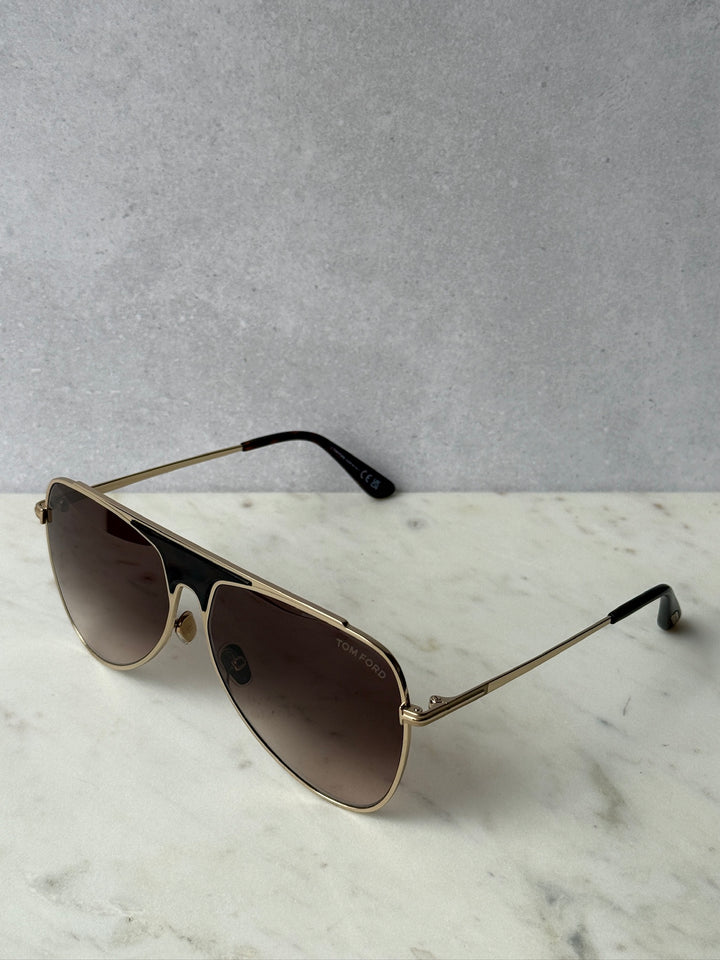 Pilot sunglasses with rose gold metal frame and dark brown lenses, black nose pads