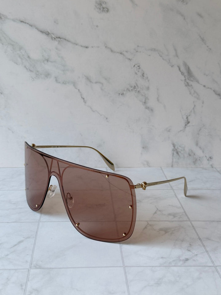 Nude oversized shield sunglasses with brown tinted lenses and slim gold arms