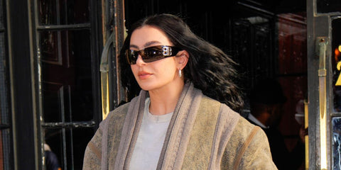 Black shield sunglasses on model, metallic BB logo and dark tinted lenses