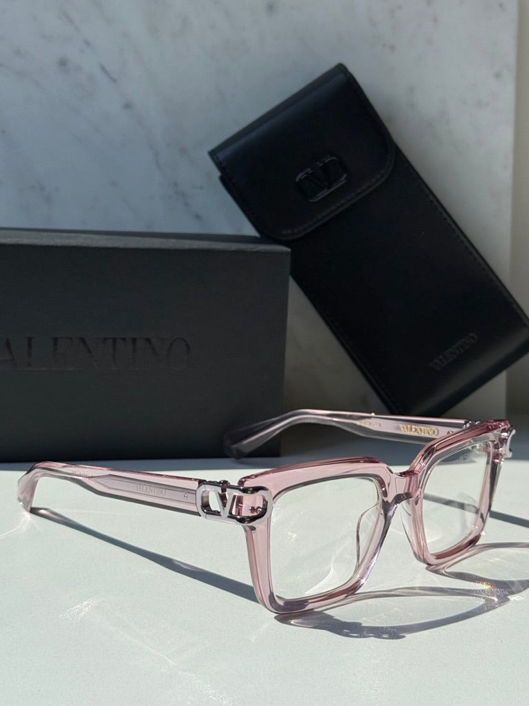 Pink square eyeglasses with clear lenses and chrome V logo hinge detail