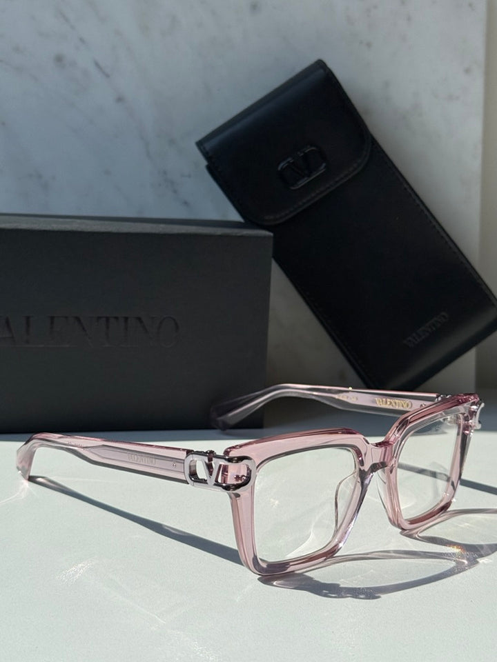 Pink square eyeglasses with clear lenses and chrome V logo hinge detail
