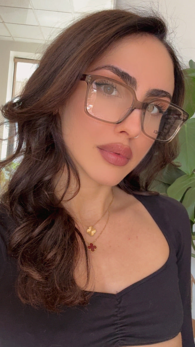 Woman wearing Fendi transparent brown eyeglasses with rectangular clear lenses