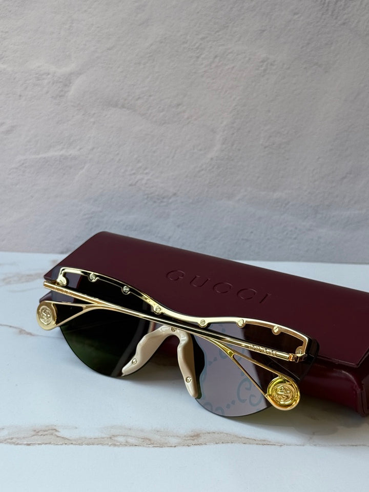 Gucci GG0666S Gafas de sol rosa espejadas con logo de ojo de gato