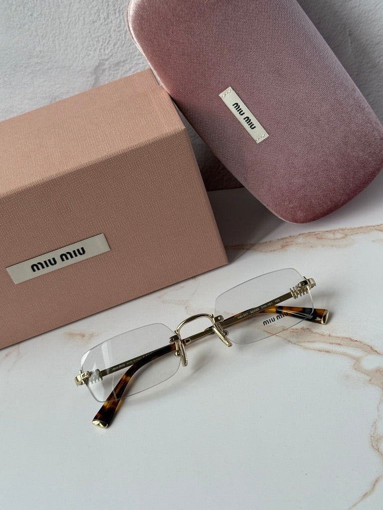 Miu Miu rimless eyeglass frames, gold metal and tortoise temple tips, front view