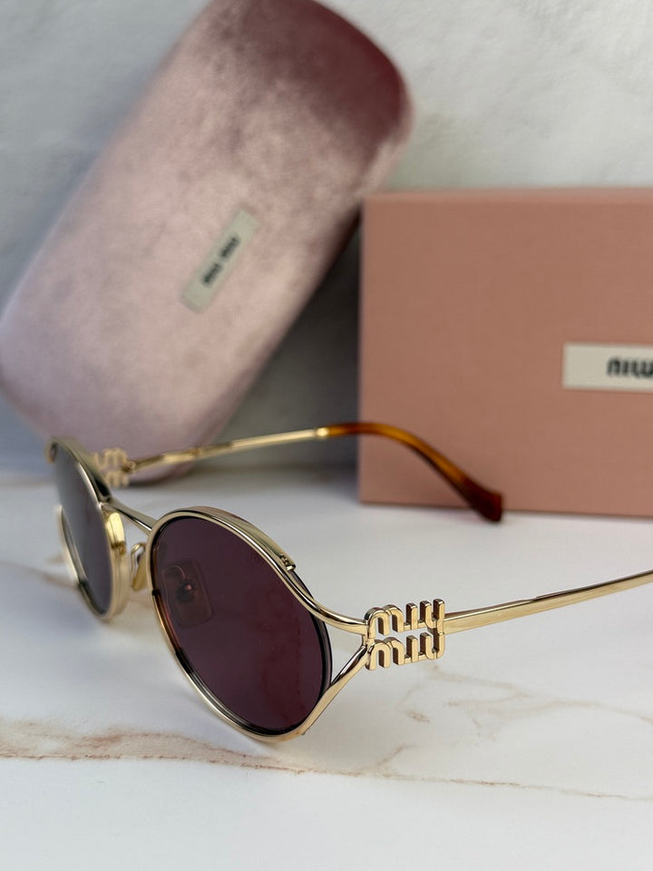 Miu Miu gold oval sunglasses with purple lenses, close side view of frame and temple.