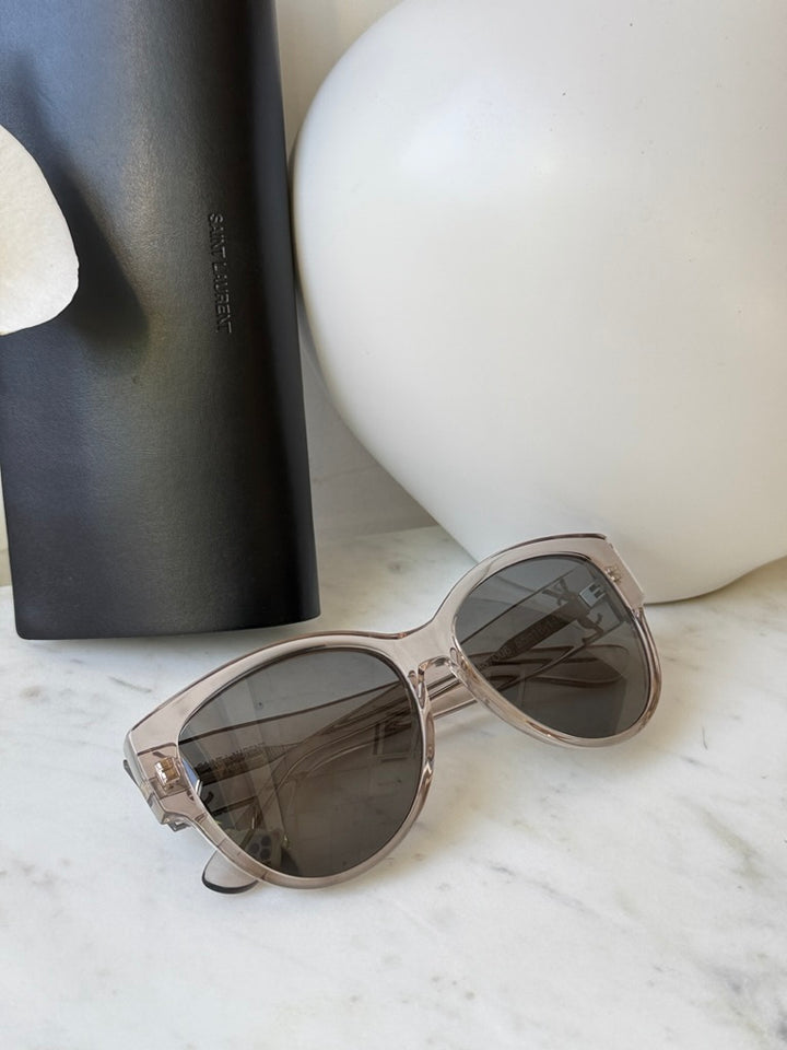 Cat-eye sunglasses in clear silver with tinted lenses, angled view