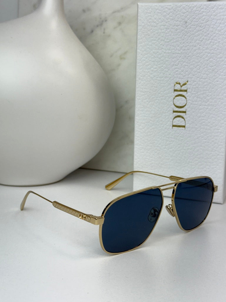 Gold-tone aviator sunglasses with dark blue lenses and Dior branding on temple