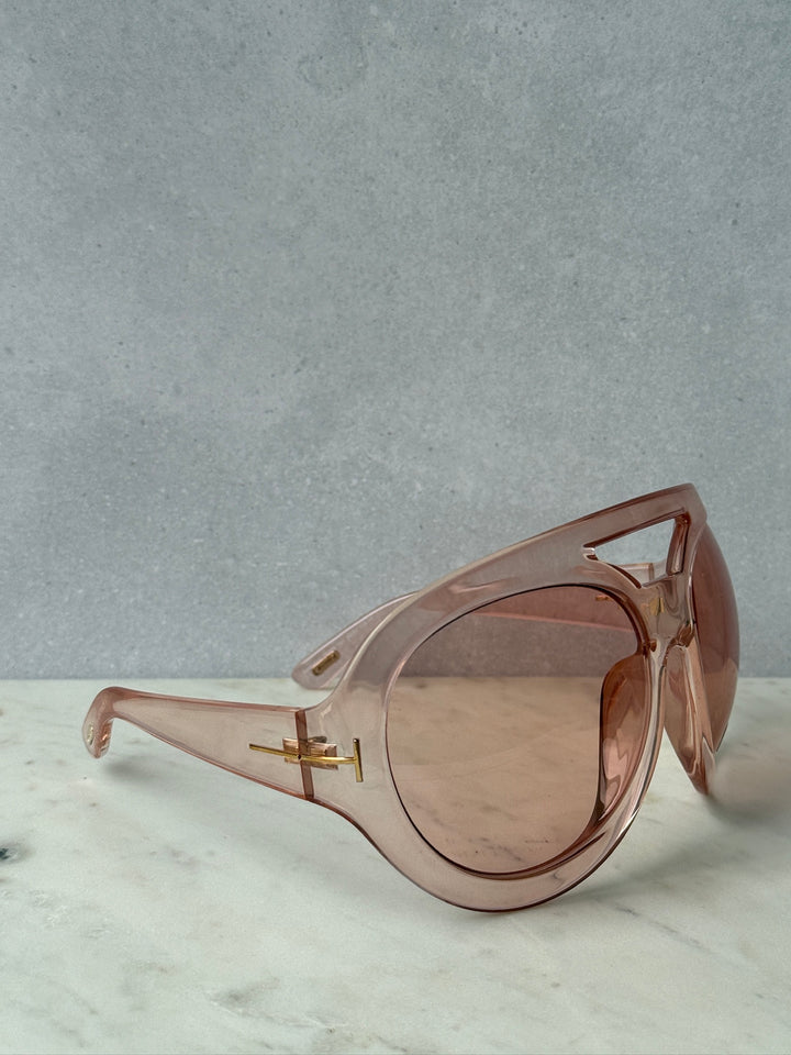 Oversized pink mask sunglasses with tinted lenses, side view and gold-tone hinge