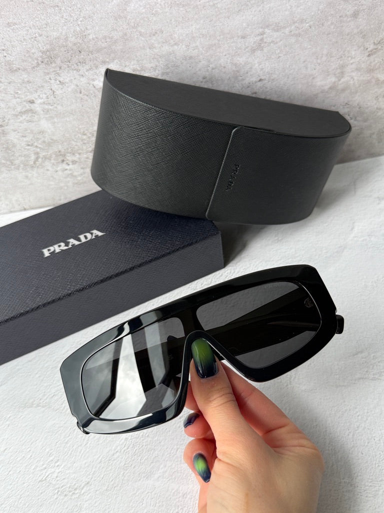Black PRADA sunglasses with dark lenses and glossy angular temples