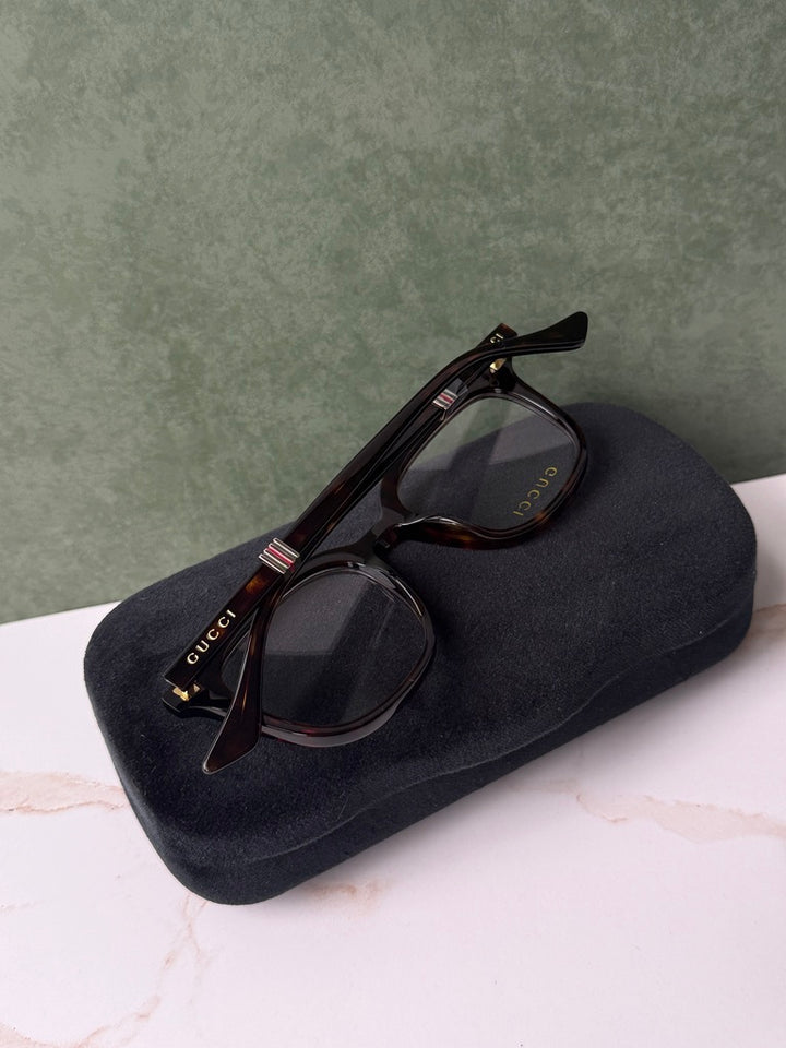 Havana brown square eyeglass frames with dark case and temple logo