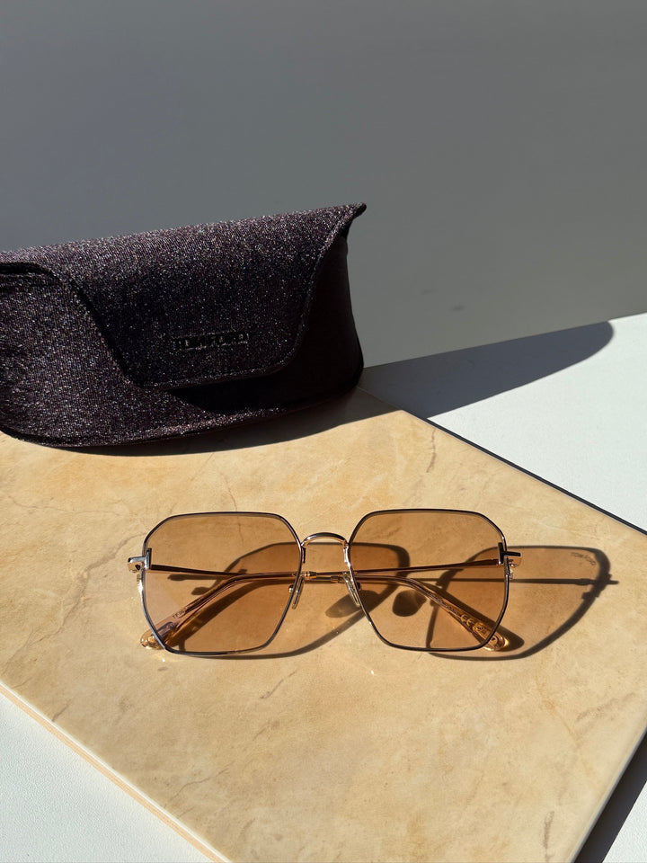 Square sunglasses with gold metal frame and amber-tinted lenses