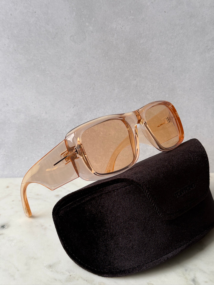 Transparent orange square sunglasses with amber lenses, with black foldable case