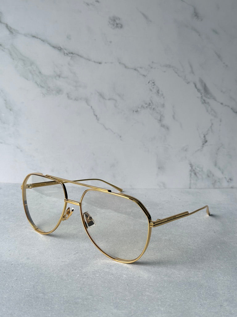 Gold aviator sunglasses with clear lenses and straight metal temple arms