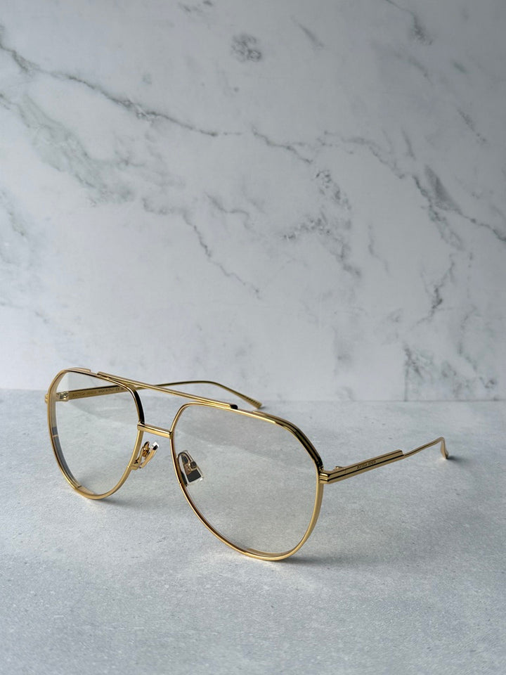 Gold aviator sunglasses with clear lenses and straight metal temple arms