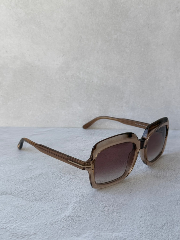 Rectangular sunglasses with translucent frame and dark tinted lenses, side profile