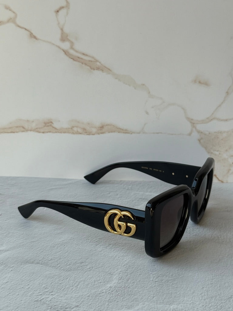 Gucci GG1975S cat-eye sunglasses side view, black frame with gold GG logo