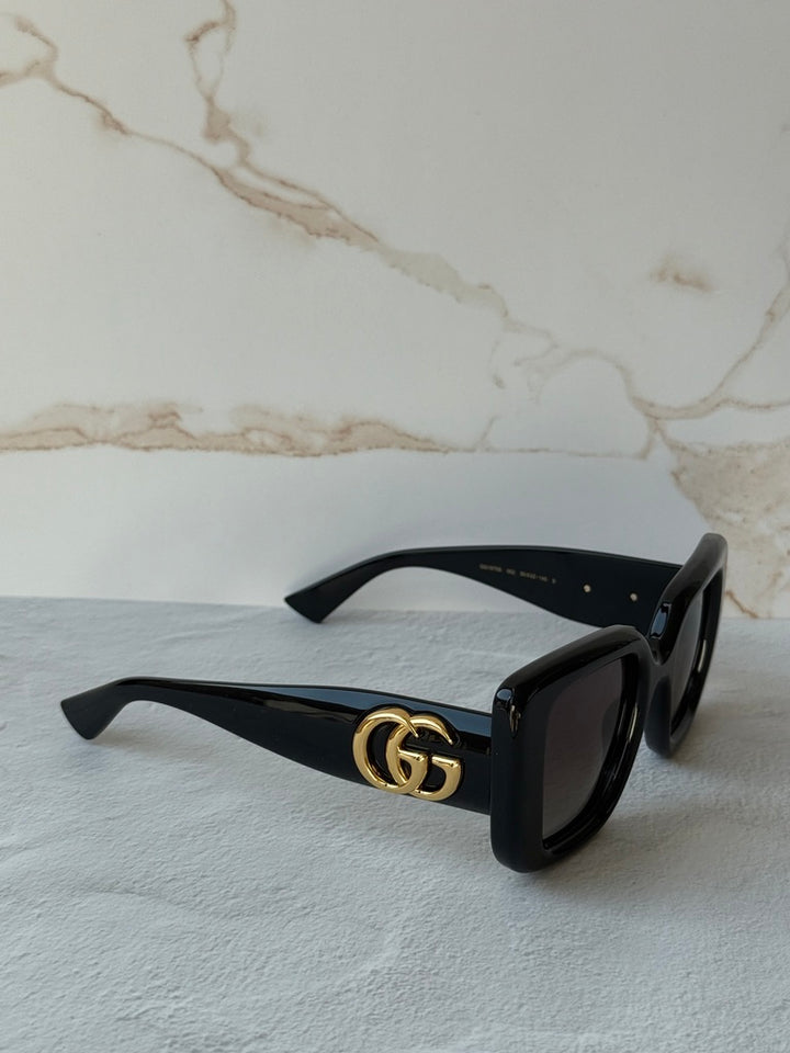 Gucci GG1975S cat-eye sunglasses side view, black frame with gold GG logo