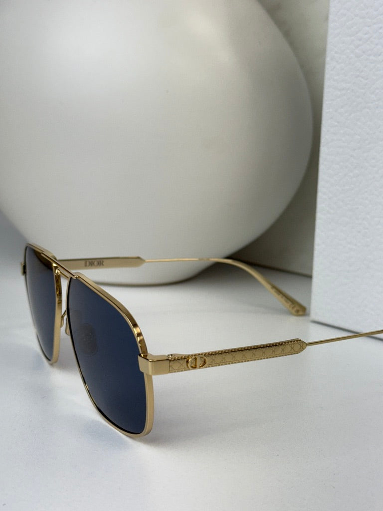 Gold aviator sunglasses with dark blue lens and thin metal arms