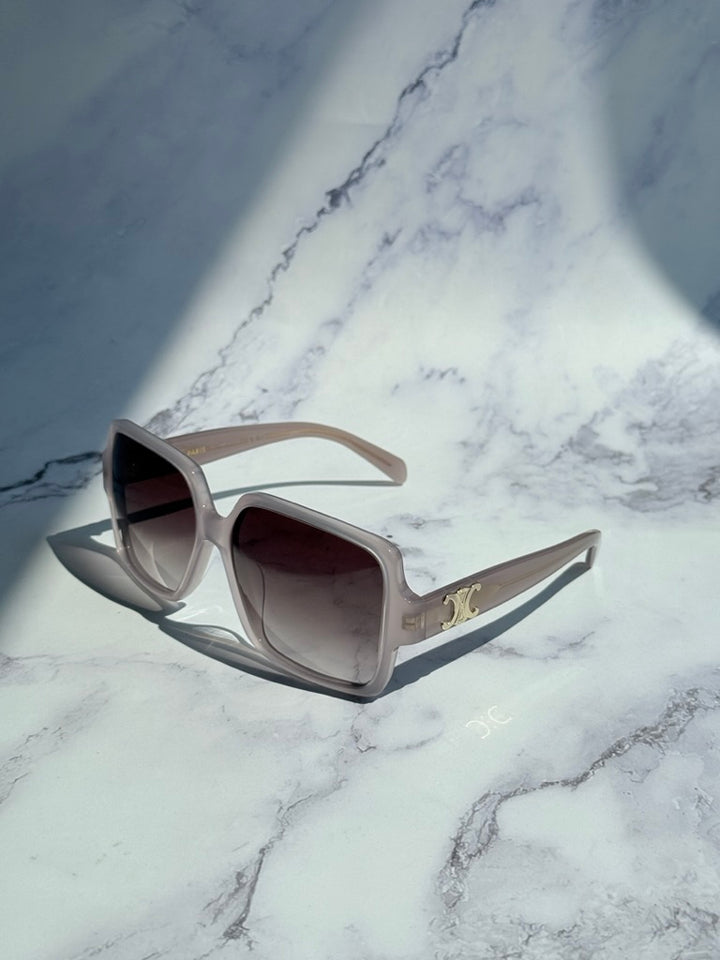 Taupe square sunglasses with brownish tinted lenses and gold emblem on temple