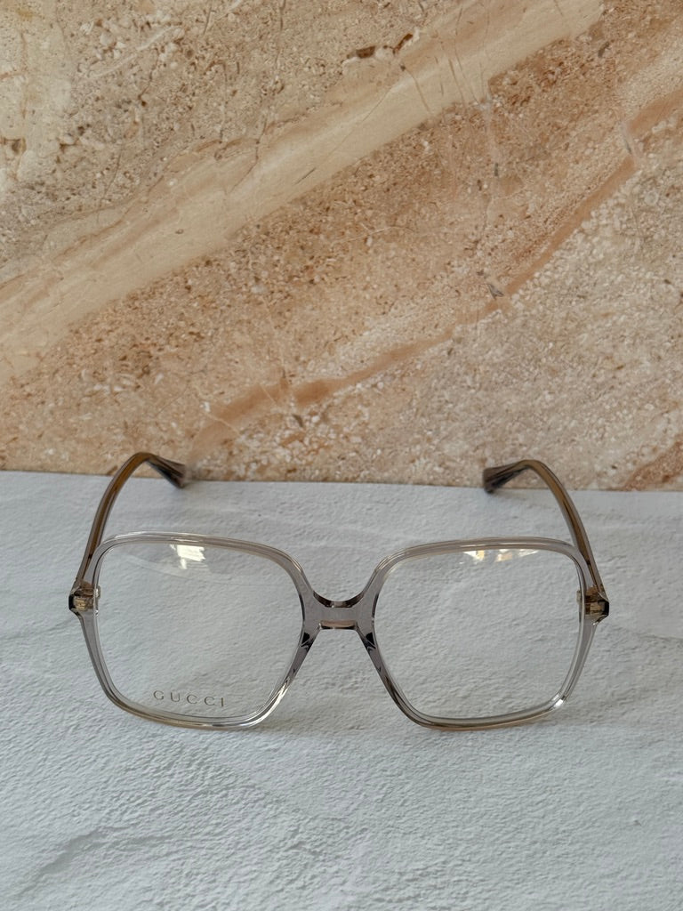 Gucci transparent grey rectangular eyeglass frames, front view with bridge cutout