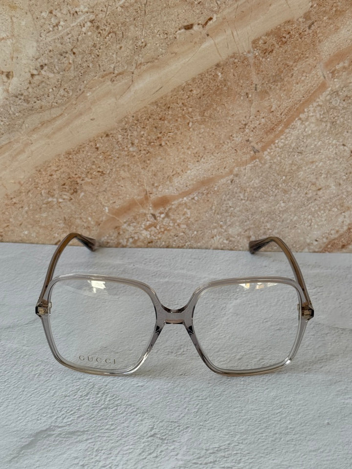 Gucci transparent grey rectangular eyeglass frames, front view with bridge cutout