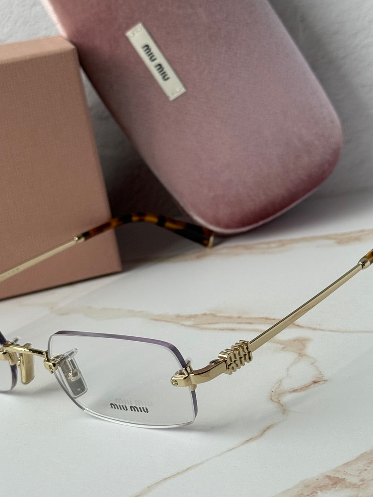 Miu Miu rimless eyeglass frames, gold arms and tortoise temples with clear lenses