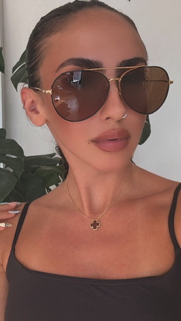 Tom Ford aviator sunglasses with brown lenses on model