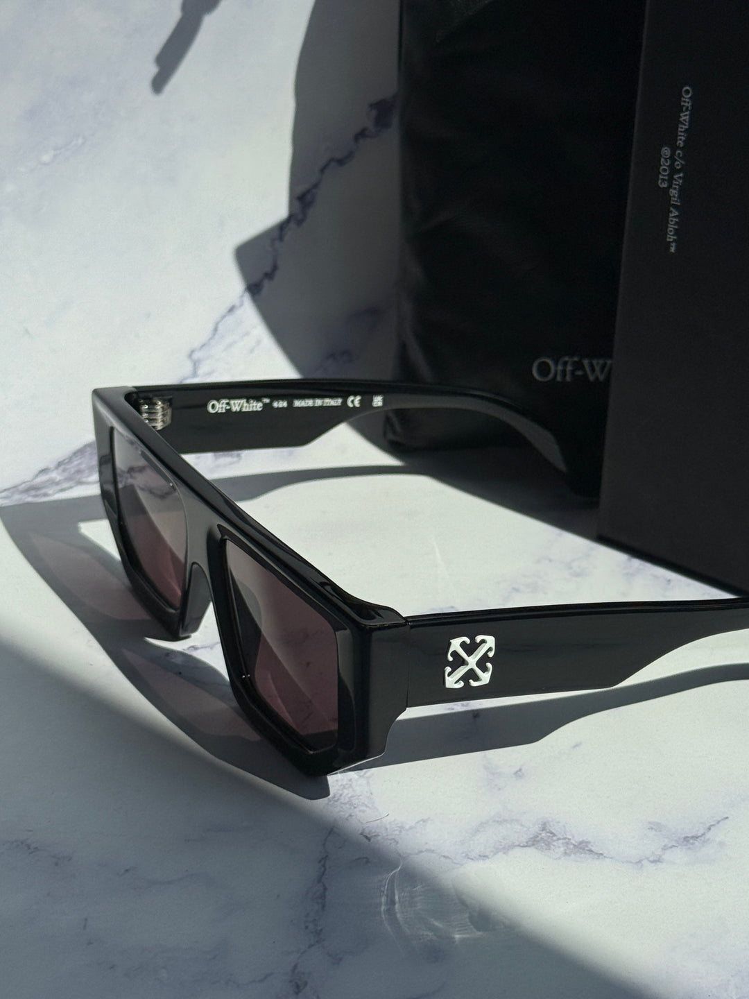 Off-White black square sunglasses with dark lenses, close angled