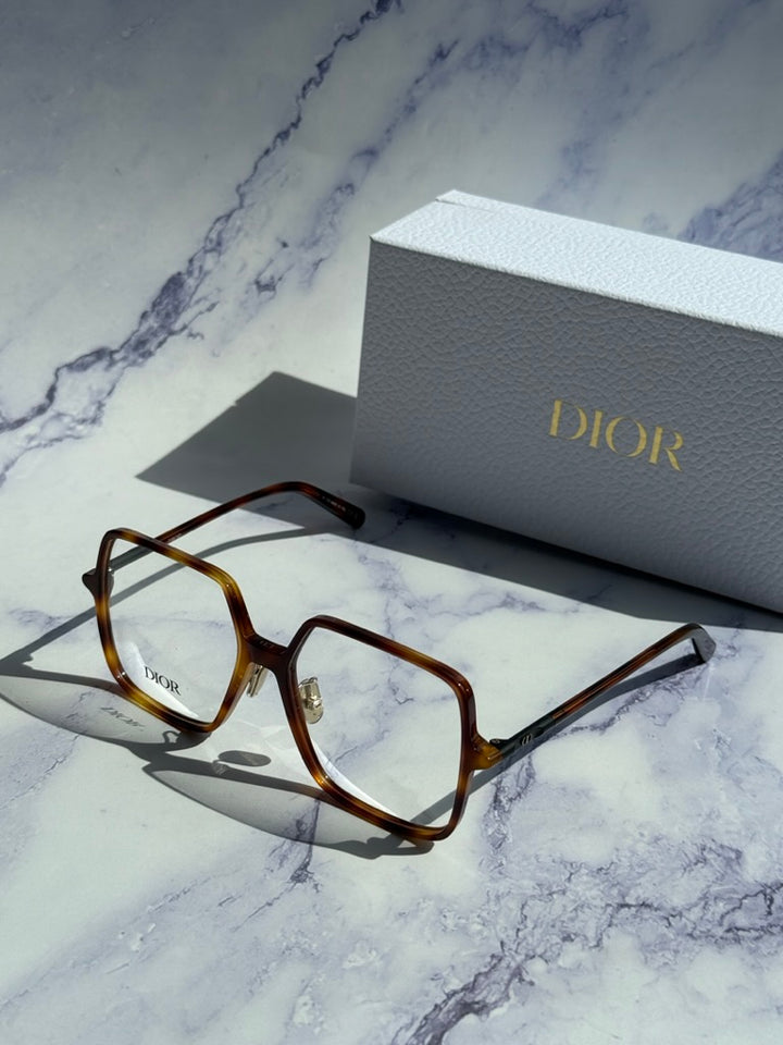 Havana brown square eyeglasses with Dior logo beside white Dior gift box