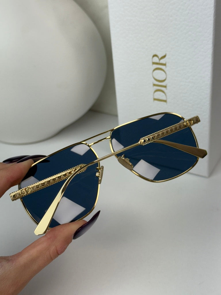Gold-tone aviator sunglasses with dark blue lenses and engraved temple arms