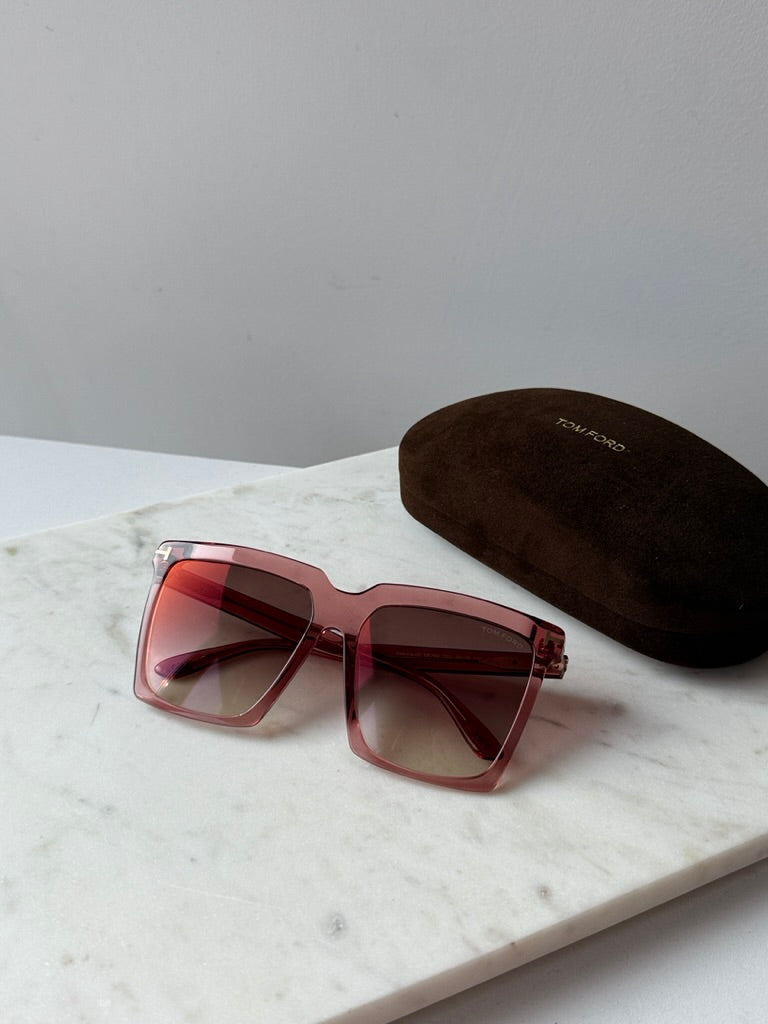 Pink square sunglasses with brown gradient lenses, dark case behind