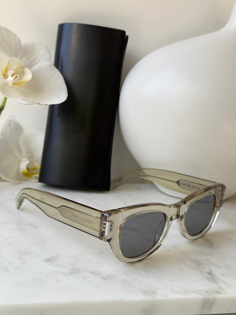 Saint Laurent SL573 clear mirror sunglasses angled with dark lenses and slim arms