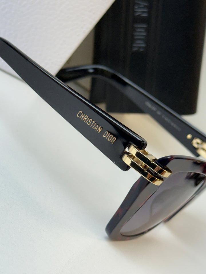 Oversized butterfly sunglasses with gold Christian Dior logo on dark temple, dark lenses