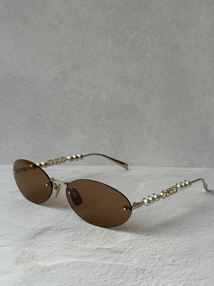 Gucci GG1257S Gafas de sol redondeadas con lentes marrones y rojos