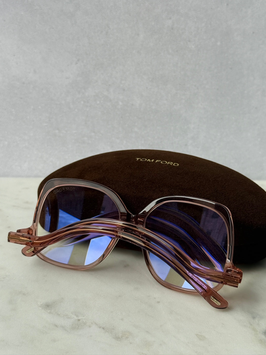 Pink oversized blue-light glasses frames with blue-tinted lenses, side view
