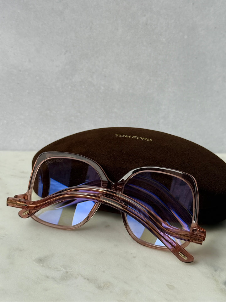 Pink oversized blue-light glasses frames with blue-tinted lenses, side view