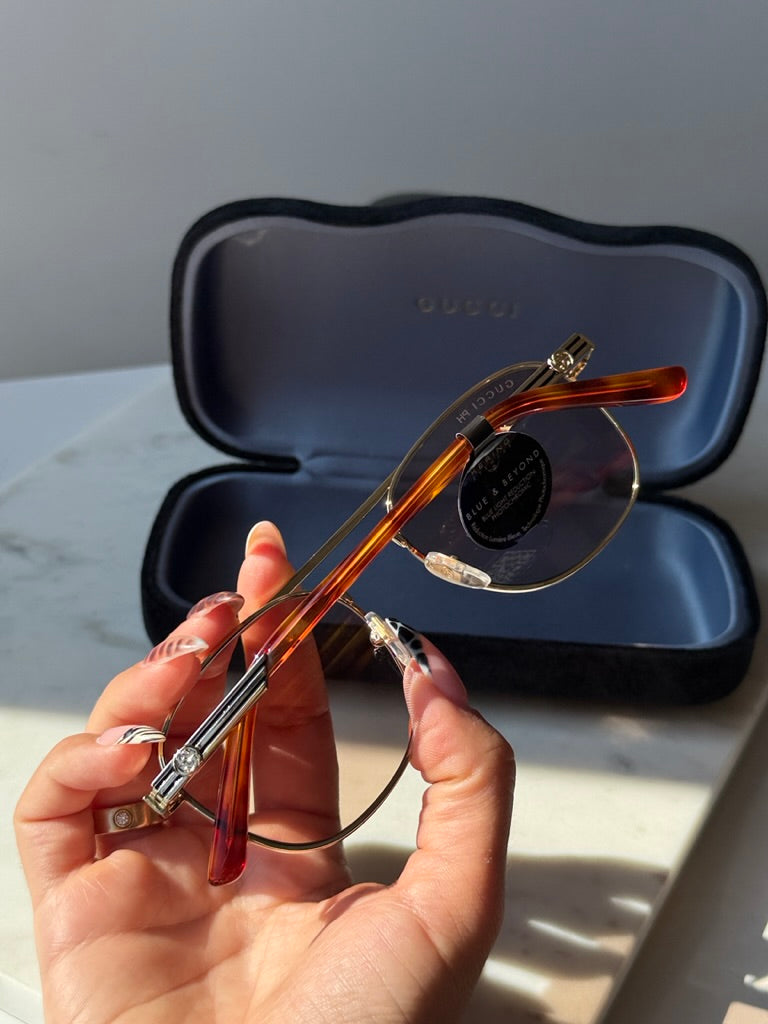 Gucci pilot sunglasses, gold frame and tortoise temples with photochromic lenses