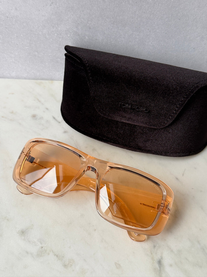 Transparent orange rectangular sunglasses with amber lenses, shown with black protective case
