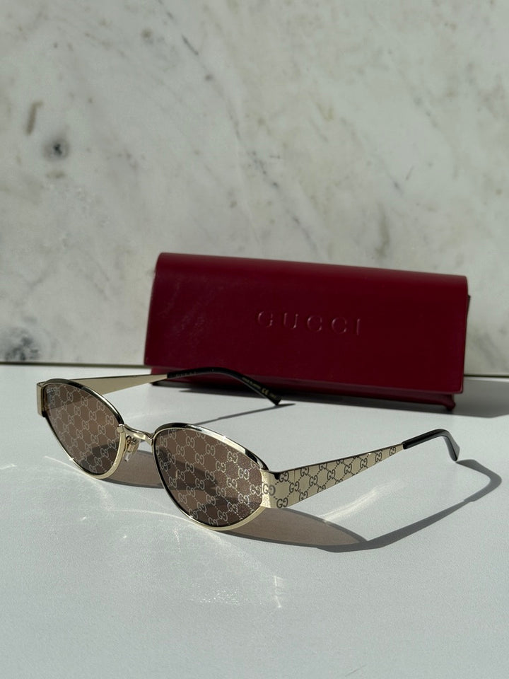 Gucci cat-eye sunglasses with GG monogram brown lenses and gold-tone metal frame