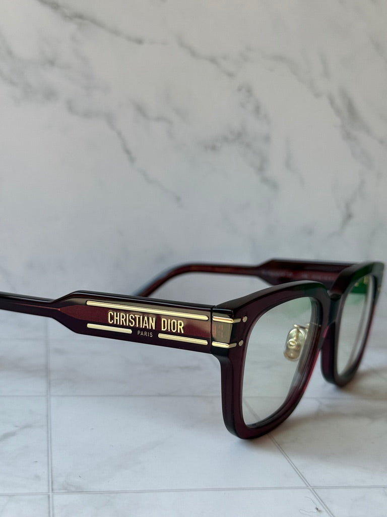 Burgundy Dior eyeglass frames with CHRISTIAN DIOR PARIS logo on arm