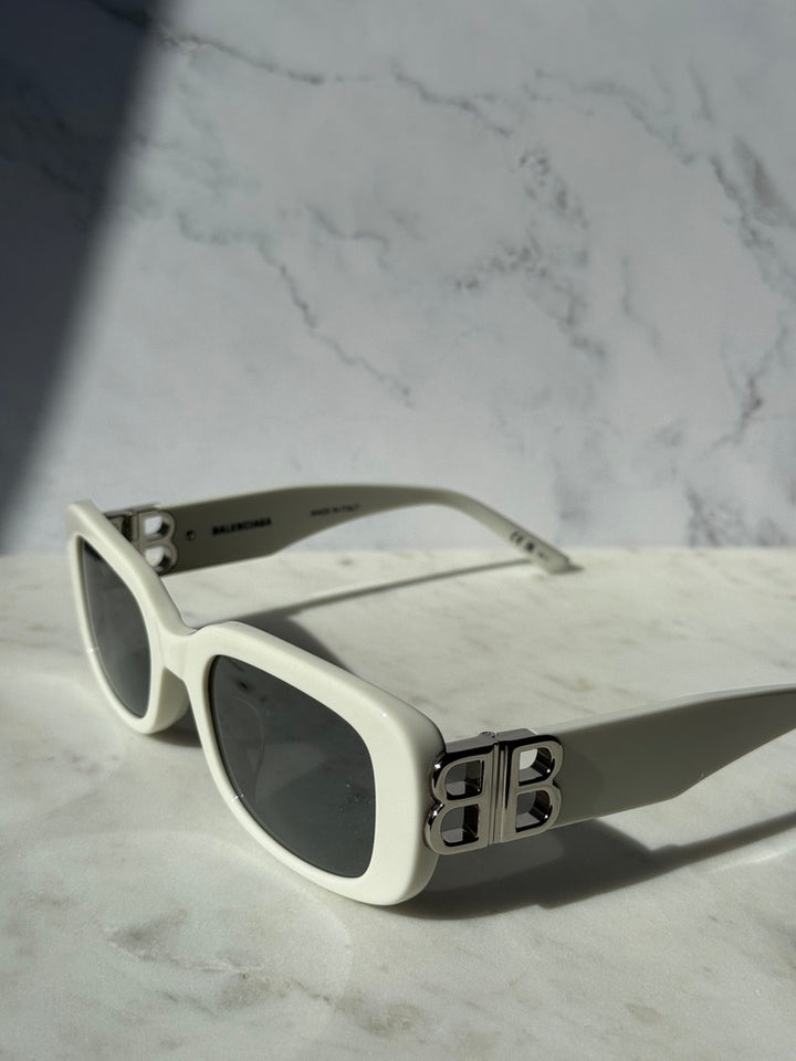 White square sunglasses with dark lenses and B monogram on temple, side profile