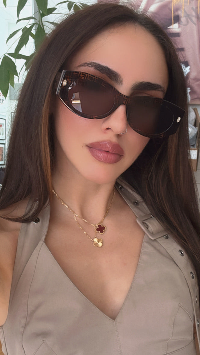 Tortoiseshell sunglasses with FF logo temple and dark oval lenses on face