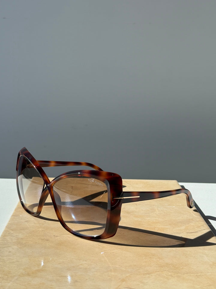 Oversized cat-eye sunglasses on display, Havana brown frame and amber-tinted lenses